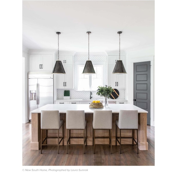 Kitchen with French Chandeliers, a wooden kitchen island and chairs